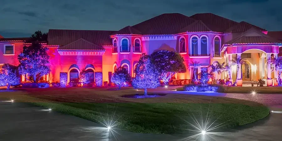 Professional holiday lighting display installed on a luxury home in Omaha, NE at night