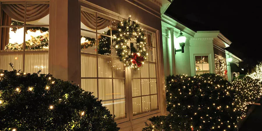 In front of a house installed holiday lighting decor